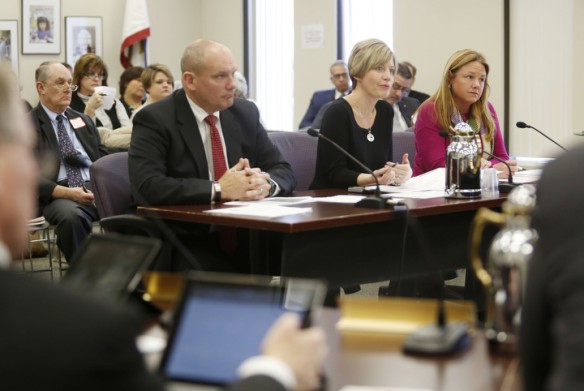 Kentucky Department of Education Chief of Staff Tommy Floyd and Associate Commissioners Amanda Ellis and Kelly Foster discuss closing the achievement gaps through novice reduction with the Kentucky Board of Education during its meeting. Photo by Amy Wallot, Feb. 4, 2015