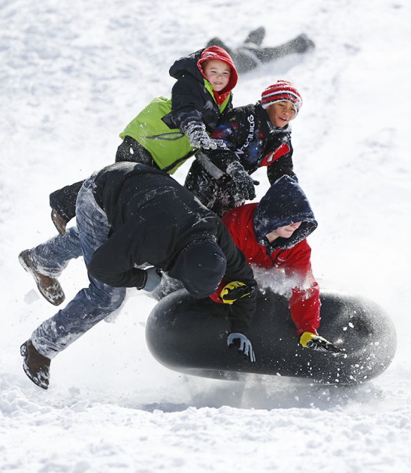 A group of students fall off and inner tube while sledding at Stonewall Elementary School (Fayette County).
