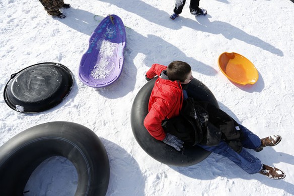 A student waits for his turn to sled down the hill at Stonewall Elementary School (Fayette County).