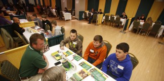 Anderson County Middle School 8th-grade students Alan Burkhead, Dalton Beasley and Ryan Madden discuss career options in agriculture with Eddie Reed and John Sedlacek during Operation Preparation at Kentucky State University. Photo by Amy Wallot, March 11, 2015