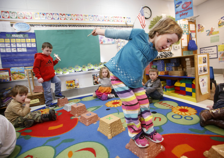 Preschool student Sarissa Bowman makes her way across balancing blocks on her way to centers in Felechia Wainscott's class in Owen County. Photo by Amy Wallot, March 12, 2015