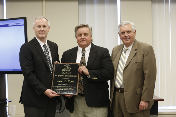 Kentucky Board of Education Vice Chairman Jonathan Parrent, left, and Commissioner Terry Holliday, right, pose with Taylor County superintendent Roger Cook after he received the Dr. Johnnie Grissom Award from the Kentucky Board of Education. Photo by Amy Wallot, April 1, 2015