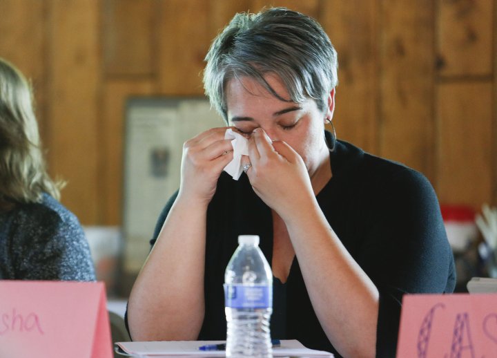 Sasha Reinhardt, a language arts teacher at Bath County Middle School, wipes a tear after learning about Irena Sendlerowa during "Social Justice-Centered Classrooms: A Writing and Thinking Retreat" at General Butler State Resort Park. Sendlerowa was a Polish woman who hid Jewish children during the Holocaust. Photo by Amy Wallot, June 25, 2015