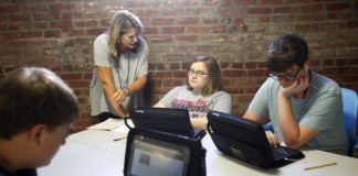 Owensboro Innovation Academy teacher Jennifer Cecil helps freshman Juliana Cefus, an Owensboro Independent student, with a project in World Studies in English. Photo by Amy Wallot, Aug. 24 , 2015