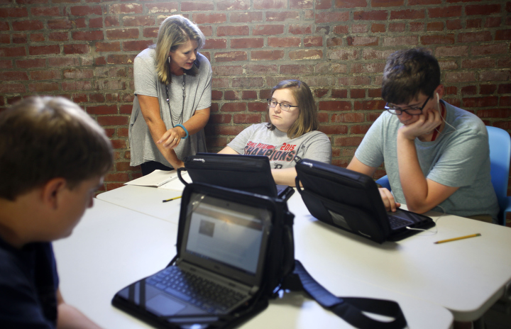 Owensboro Innovation Academy teacher Jennifer Cecil helps freshman Juliana Cefus, an Owensboro Independent student, with a project in World Studies in English. Photo by Amy Wallot, Aug. 24 , 2015