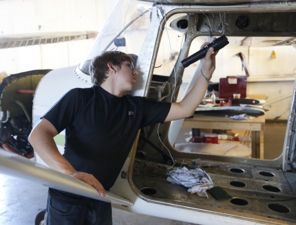 Tristan Hamilton, a student at Henry County High School, works on an airplane at The National Air & Space Education Institute at Bowman Field in Louisville. Photo by Mike Marsee, Sept. 22, 2015