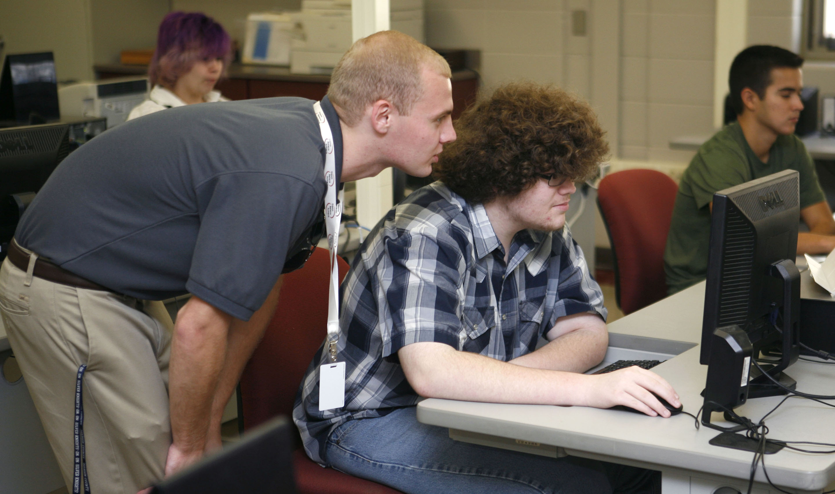 Dylan Tungate, a technology instructional assistant for Marion County Schools, looks on as Zach Nalley works on a Microsoft IT Academy course in Anita Milburn’s information technology class at Marion County Area Technology Center. Photo by Mike Marsee, Nov. 4, 2015
