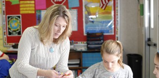 Beaumont Middle School Teacher Laura Roché, the 2015 Kentucky World Language Association’s Outstanding Teacher, shows a student crayons while teaching colors. Brenna R. Kelly, Nov. 12, 2015