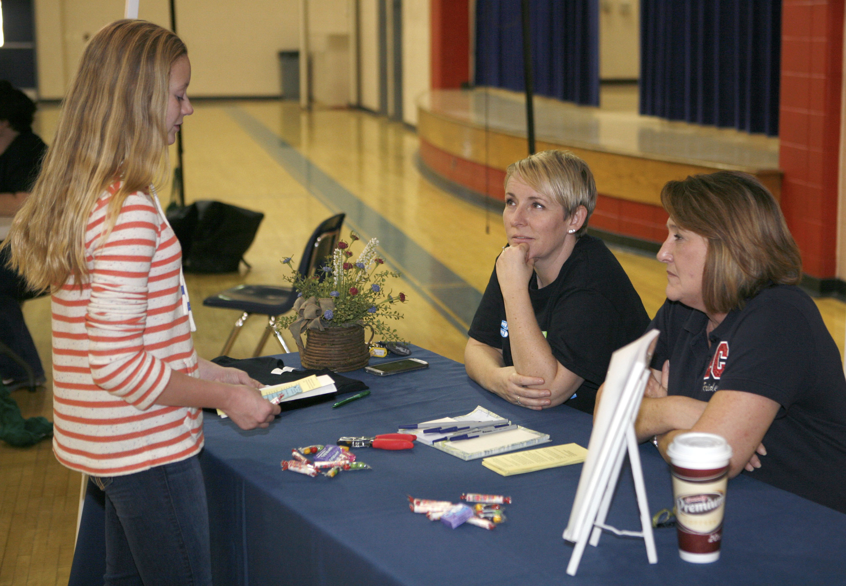 East Carter Middle School (Carter County) Assistant Principal Kelley Moore, center, and Principal Jenny Stark, right, talk with 8th-grader Kady Lewis during a parent night held to raise awareness about the Olweus Bullying Prevention Program, which the school implemented earlier this year. Photo by Mike Marsee, Nov. 12, 2015