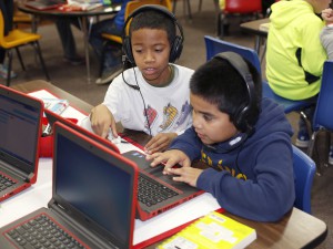 Third-graders Tyrese Myrick and Omar Hernandez-Resa code on laptops during Hour of Code at Beechwood Elementary last school year. Dec. 7, 2015 Brenna Kelly 