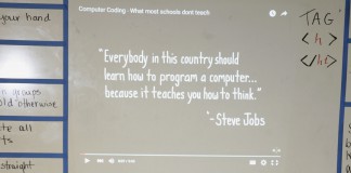 A quote from Apple Inc. co-founder Steve Jobs was projected on the whiteboard as students Robbie Craig, left, and Jayden Banks work at their computers during an Hour of Code activity last school year in Ashley Rosen’s integrated science class at the STEAM Academy (Fayette County). Photo by Mike Marsee, Dec. 9, 2015