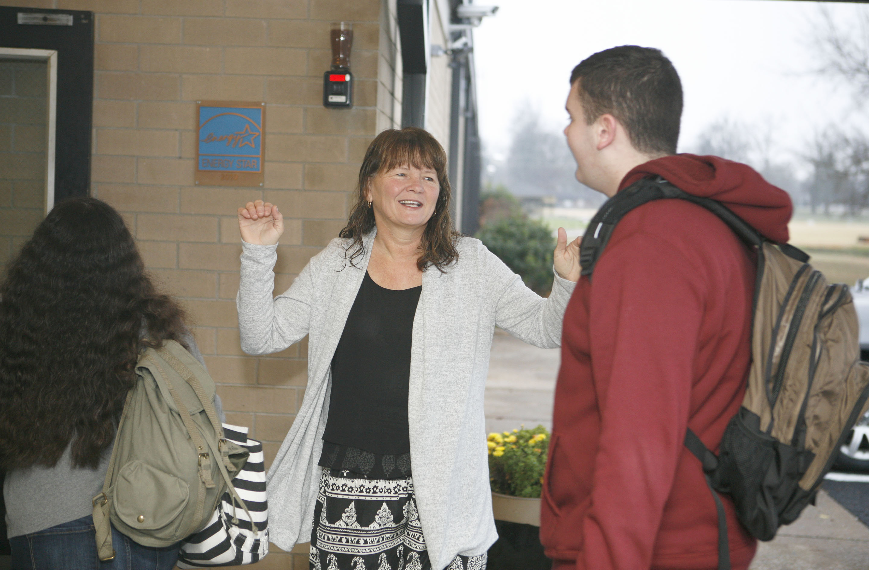 Teresa Speed, principal at Murray High School (Murray Independent), greets students with a hug as they enter the building to start the school day. Speed hugs her students each morning, saying it helps her build relationships with students that are critical to their success. Murray was named a 2015 National Blue Ribbon School by the U.S. Department of Education. Photo by Mike Marsee, Dec. 11, 2015