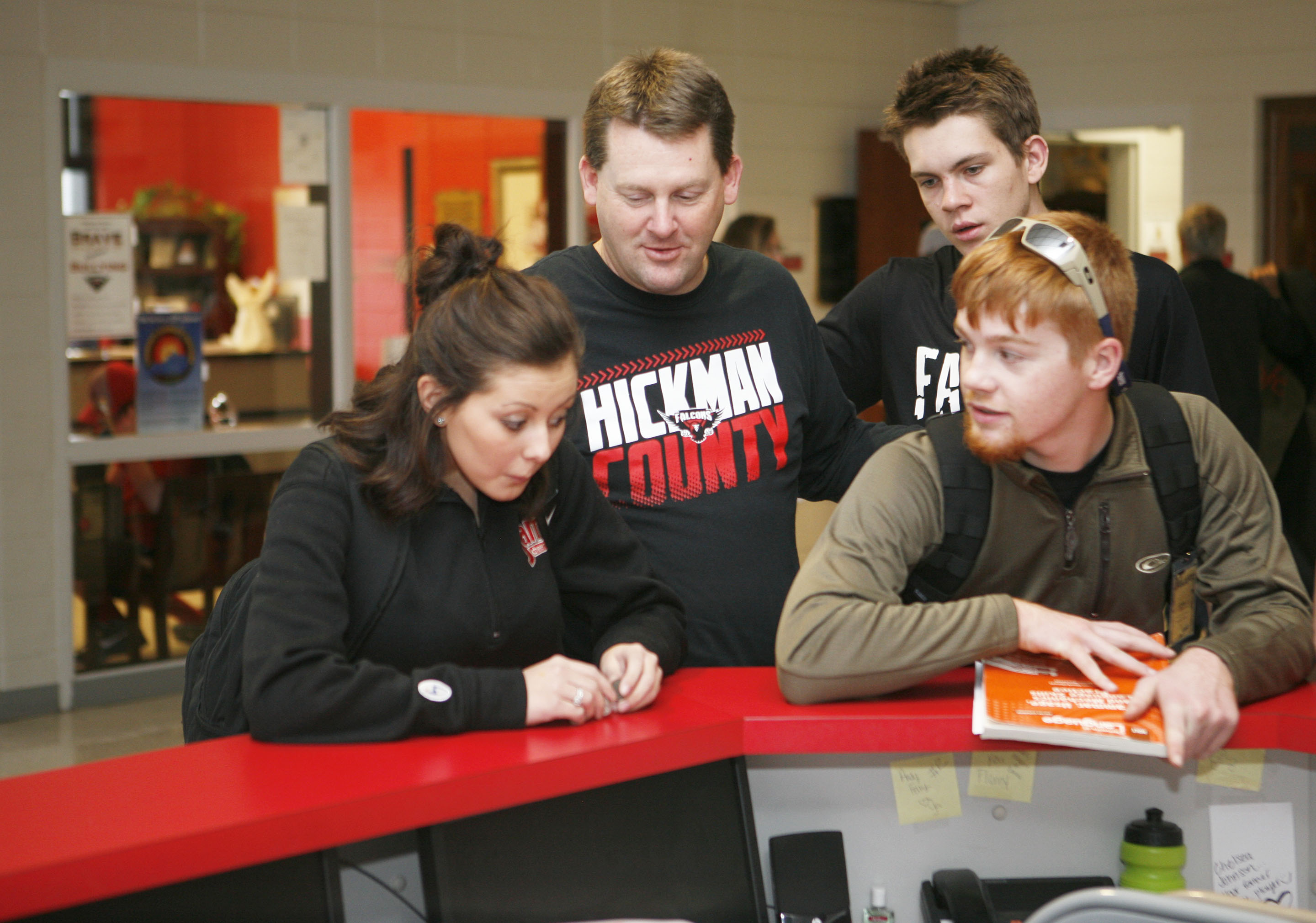 Kevin Estes, the principal at Hickman County High School, talks with students between class periods in the school lobby. Estes also regularly communicates with administrators from around the state while serving as one of the moderates of a weekly Twitter chat for administrators. Photo by Mike Marsee, Dec. 11, 2015