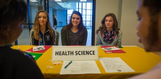 Owen County Middle School students Bella Carmack, left, Addison Montague and Alli Gill speak to Floarine Wilson and Justice McAllister about health science professions during Operation Preparation at Kentucky State University. Photo by Bobby Ellis, March 15, 2016