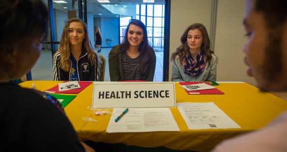 Owen County Middle School students Bella Carmack, left, Addison Montague and Alli Gill speak to Floarine Wilson and Justice McAllister about health science professions during Operation Preparation at Kentucky State University. Photo by Bobby Ellis, March 15, 2016