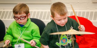 Dawson Barr, left, plays a snare drum while Hayden Ashley tests a cymbal during a program at the American Printing House for the Blind held in conjunction with the Kentucky Regional Braille Challenge. Younger students participating in the competition tried their hand at a variety of percussion instruments during a program held while their work was being judged. Photo by Mike Marsee, Feb. 18, 2016