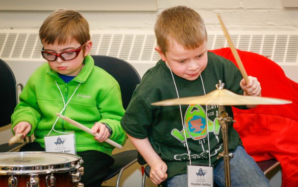 Dawson Barr, left, plays a snare drum while Hayden Ashley tests a cymbal during a program at the American Printing House for the Blind held in conjunction with the Kentucky Regional Braille Challenge. Younger students participating in the competition tried their hand at a variety of percussion instruments during a program held while their work was being judged. Photo by Mike Marsee, Feb. 18, 2016
