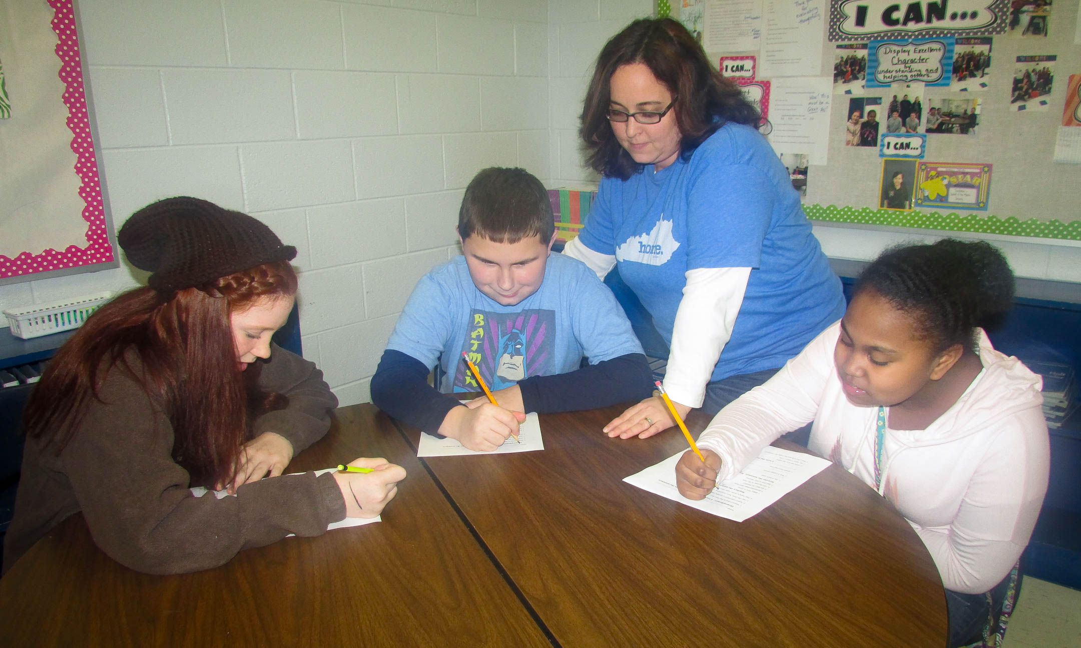 Special Education Teacher of the Year Kelly Teague works with Hayden Gray (center) and his peer buddies Daznee Johnson (left) and Erica Shelton (right) at Muhlenberg North Middle School. Teague created the group to help Gray, who has autism, with social skills. Photo submitted by Muhlenberg County Schools.
