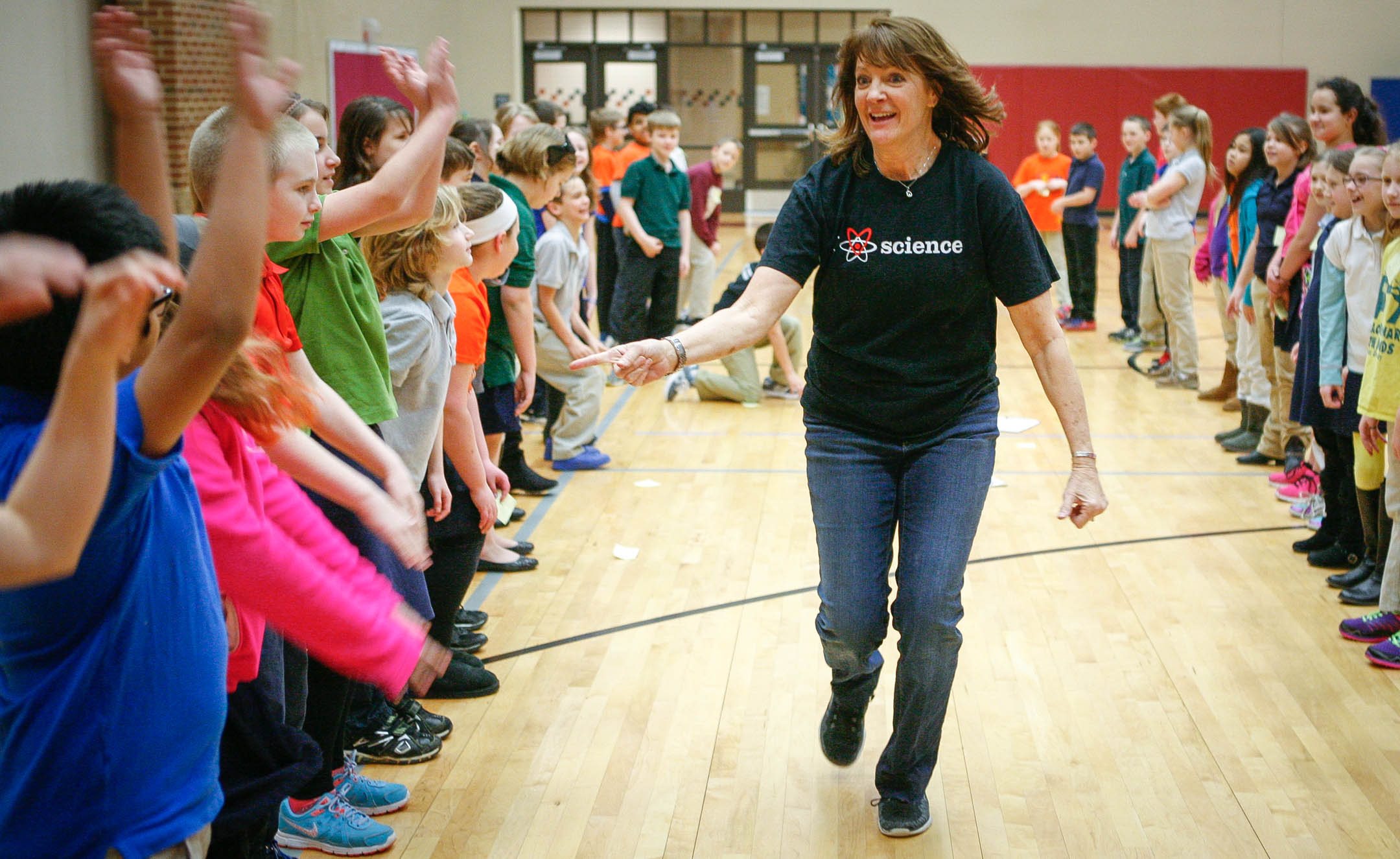 Sharon Roberson, a science lab teacher at Brooks Elementary (Bullitt County) demonstrates sound waves by having students do the wave during a lesson on the science of music. Photo by Mike Marsee, Feb. 19, 2016