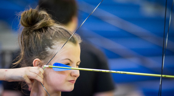 Lauren Campbell, a 5th-grader at Spencer County Middle School, takes aim at a target during the weekly archery club that is part of the school’s Grizzlies Beyond the Bell after-school program, which offers students an hour in which they can get help with class assignments or catch up on homework, followed by an hour of activity in one of a number of clubs. Photo by Bobby Ellis, March 30, 2016
