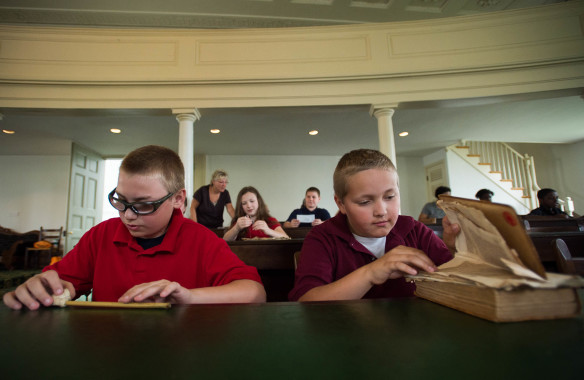 Dennis Wright, left, and Gideon Berry look at props in the House chamber of the Old Capitol building on a field trip to Frankfort. Photo by Bobby Ellis, April 19, 2016