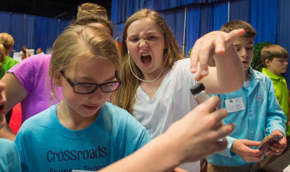 Maddy Tobbe, a 5th-grader from Crossroads Elementary (Bullitt County) reacts to a preserved insect at the Kentucky Department of Water booth at the Youth Summit and Awards Luncheon.