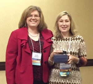 Lydia Kohler presents the 2015 Kentucky French Teacher of the Year award to Laura Roche Youngworth at the annual American Association of Teachers of French of Kentucky meeting. Photo submitted by Laura Roche Youngworth