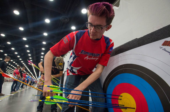 Michael Daniele, a 9th-grader at Edmonson County High School, removes arrows from the target after a practice round during the NASP National Tournament in Louisville.