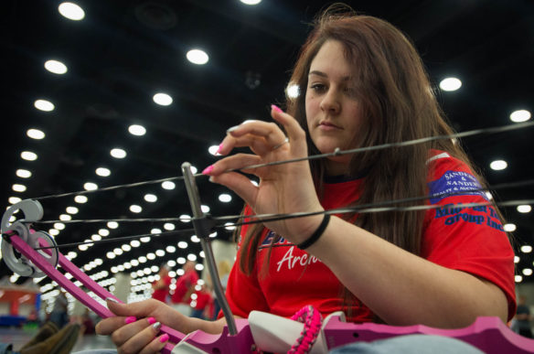 Brianna Webb, a 10-th grader at Edmonson County High School, waxes her bow string before competition.