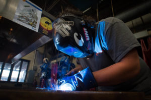 Tristian Barrera, a student at the Barren County Area Technology Center, uses an arch welder during the welding class. Students in the class helped to make a metal ornament for the bus being used by the #BCReadsandFeeds program. Photo by Bobby Ellis, April 29, 2016