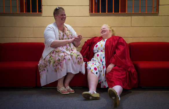 Brandy Hively, left, laughs with her daughter, Savannah Hively, before the start of the graduation ceremony at the Kentucky School for the Blind in Louisville. Photo by Bobby Ellis, May 25, 2016