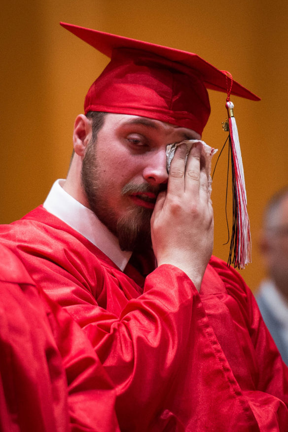 Austin Stephens wipes away tears following the rose ceremony during graduation at the Kentucky School for the Blind in Louisville. The seniors of the class each gave out three roses to people who helped to inspire them in school. Photo by Bobby Ellis, May 25, 2016