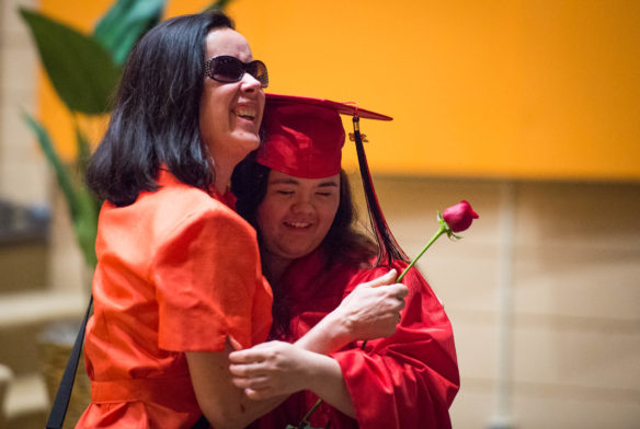 Selena Tirey hugs Pam Cox, a teacher at the Kentucky School for the Blind, during the graduation ceremony. Photo by Bobby Ellis, May 25, 2016