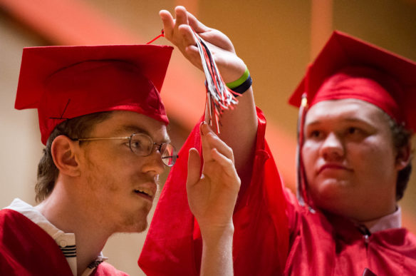 Matthew Caudill, right, helps Kenneth Breeden turn his tassel during the graduation ceremony at the Kentucky School for the Blind in Louisville. Photo by Bobby Ellis, May 25, 2016