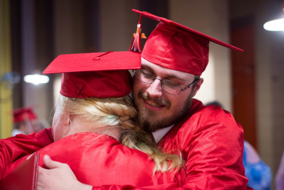 Austin Stephens and Savannah Hively hug after the graduation ceremony at the Kentucky School for the Blind. Photo by Bobby Ellis, May 25, 2016