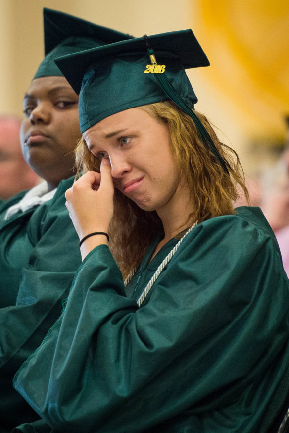 Cassandra Arnold wipes away a tear as she watches the senior video during the graduation ceremony at the Kentucky School for the Deaf in Danville. Photo by Bobby Ellis, May 27, 2016