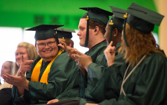 Members of the Kentucky School for the Deaf Class of 2016 sign to each other during the showing of a senior video. Photo by Bobby Ellis, May 27, 2016