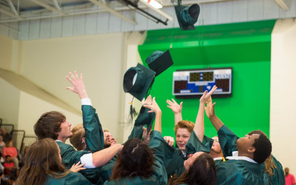 Members of the Kentucky School for the Deaf Class of 2016 throw their caps after graduating. Photo by Bobby Ellis, May 27, 2016