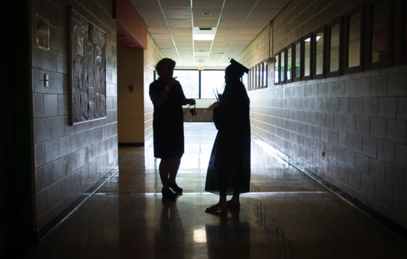 Bethany Yance, right, speaks to a teacher after the graduation ceremony at the Kentucky School for the Deaf. Photo by Bobby Ellis, May 27, 2016