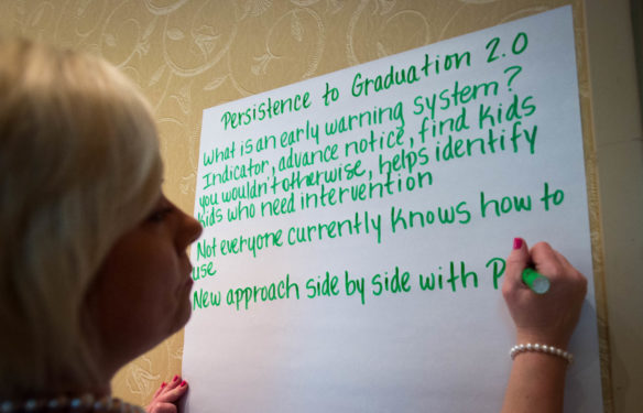 Donna Deal of the Kentucky Department of Education writes down highlights from a presentation about the Early Warning Tool at the Persistence to Graduation Summit. Photo by Bobby Ellis, June 6, 2016