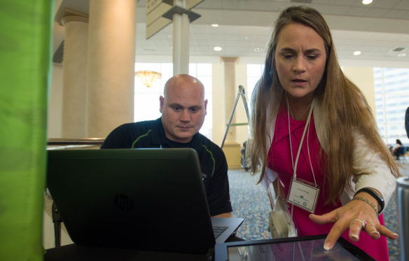 Cynthia Miracle, a guidance counselor in the Anderson County schools, asks questions of Michael Mock of Infinite Campus after a presentation on the Early Warning Tool. The tool, an updated version of the Persistence to Graduation Tool, debuted at the inaugural Persistence to Graduation Summit in Lexington. Photo by Bobby Ellis, June 6, 2016