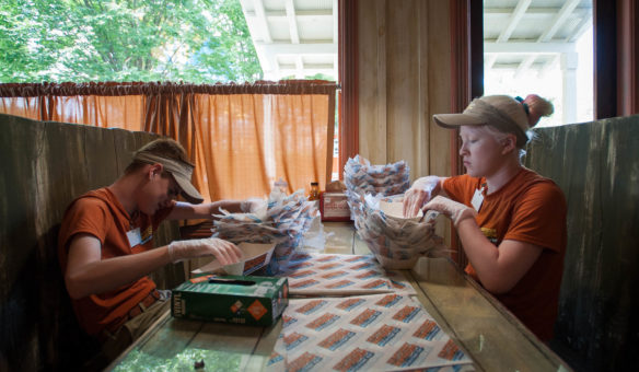 Mike Davis, left, and Amelia Lillie put paper into food containers while working at Kentucky Kingdom during the Kentucky School for the Blind Summer Work Program. Thirteen students began the two week program at Kentucky Kingdom as a way to give work experience to students. Photo by Bobby Ellis, June 24, 2016
