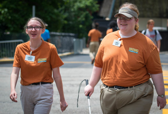 Tabitha Sutherland, left, and Abigail Cassidy walk back to their assigned positions at Kentucky Kingdom after their lunch break. Photo by Bobby Ellis, June 24, 2016