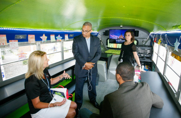 Marion County schools Superintendent Taylora Schlosser, left, and West Marion Elementary School 5th-grade teacher Lois Jean Lanham, back, describe the district’s Dream Bus to Administrator Robin Bailey, center, and Financial Management Director Izra Brown, front, of the U.S. Department of Agriculture’s Southeast Regional Office during a kickoff event for the Summer Food Service Program at Calvary Elementary School (Marion County). The repurposed school bus has been converted into a mobile learning lab and is used during the summer to deliver meals to children in communities throughout Marion County. Photo by Mike Marsee, June 14, 2016