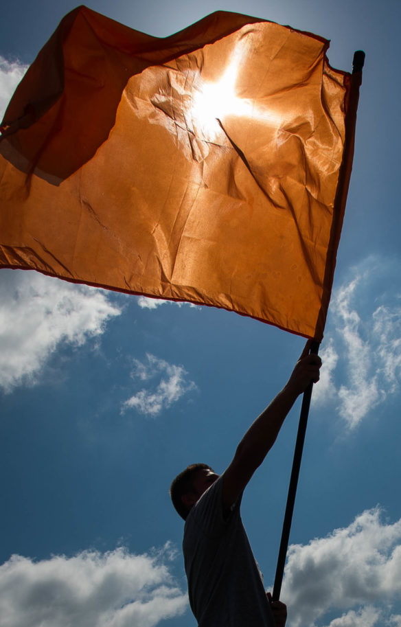 Jordan Tackett practices a flag twirl during the second day of the Johnson Central High School band camp. Photo by Bobby Ellis, July 19, 2016