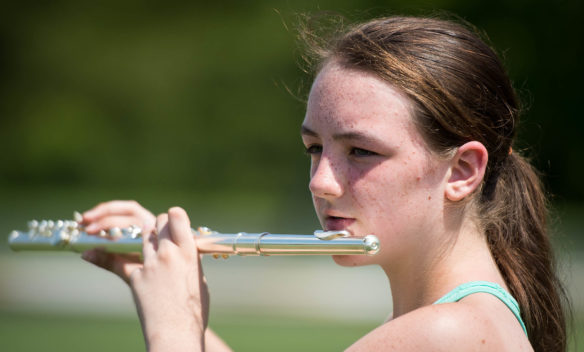 Johnson Central band member Andrea Collins plays her flute during band camp. Photo by Bobby Ellis, July 19, 2016