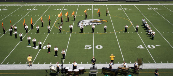 Members of the Johnson Central High School Marching Band stand at attention during the band's summer camp. Photo by Bobby Ellis, July 19, 2016