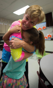 Kindergarten teacher Lori Maddux hugs her student Elissa Brown during the Meet the Teacher Night at Longbranch Elementary (Boone County). Photo by Bobby Ellis, August 9, 2016
