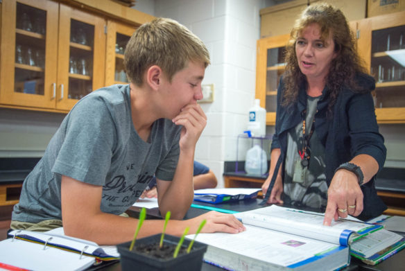 Heleen Giesbers helps sophomore Corey Fryman with homework during his honors biology class at Williamstown Junior/Senior High School. Photo by Bobby Ellis, Aug. 17, 2016