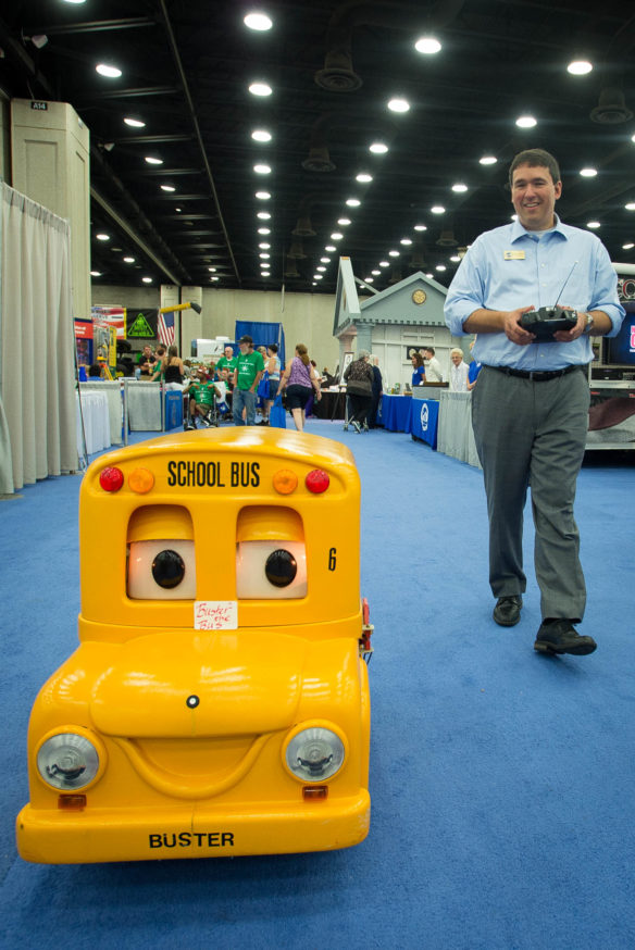 Commissioner Stephen Pruitt drives "Buster the Bus" down through a row of booths at the Kentucky State Fair. Photo by Bobby Ellis, Aug. 25, 2016